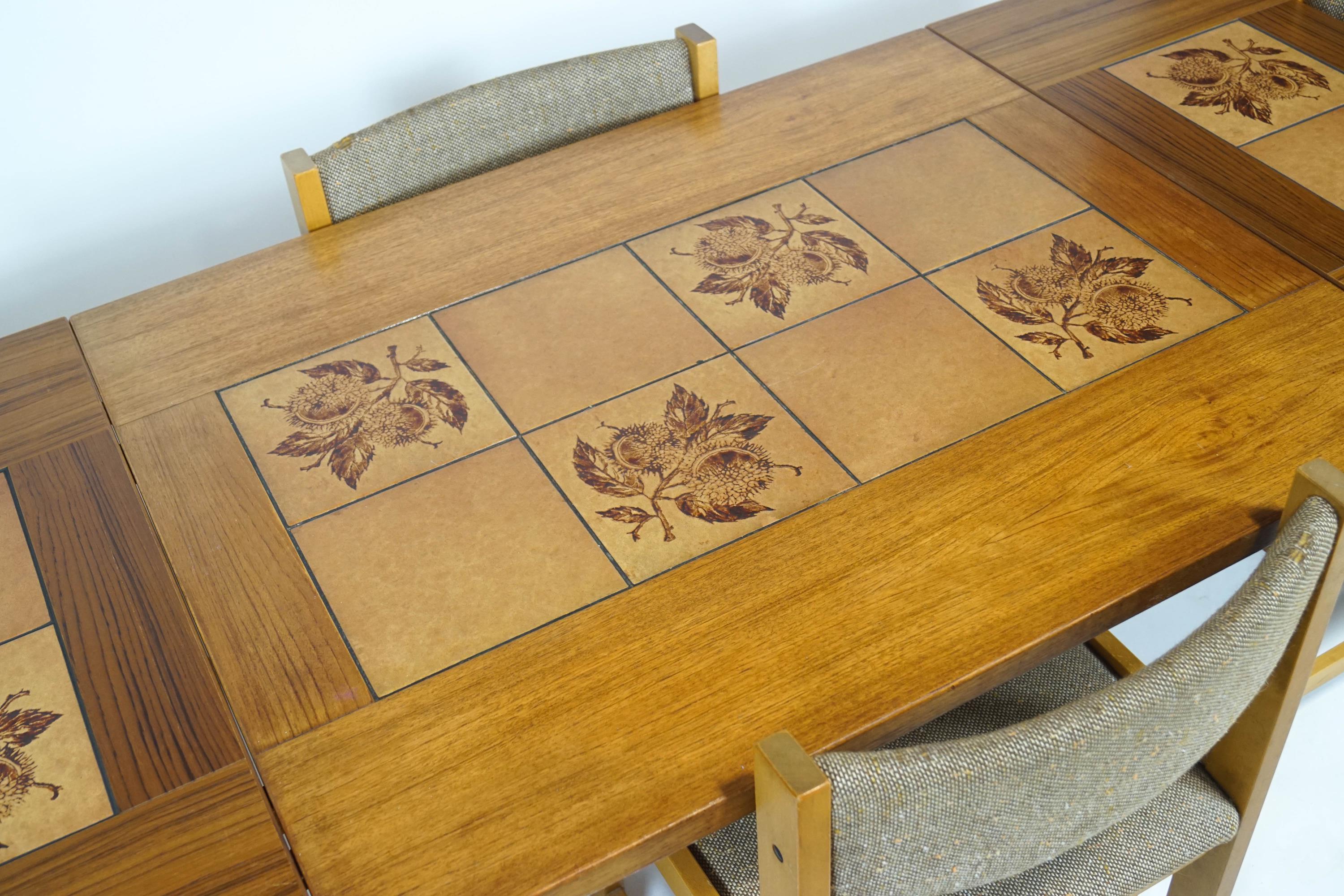 A 1970's Danish teak tile set Farstrup drop leaf dining table with four