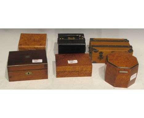 Three 20th century birds eye maple cigarette boxes, a rosewood and brass bound vanity box, black leather travelling case and 