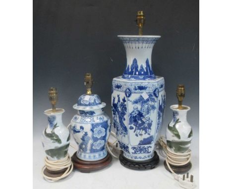 A large modern ceramic lamp of facetted baluster form in blue and white decorated with stylised lotus leaf and figural vignet