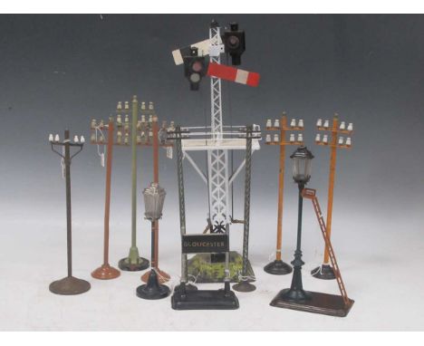 Six vintage model railway telegraph poles, painted metal, two others tinplate, a Bing lamp with ladder, another smaller lamp,