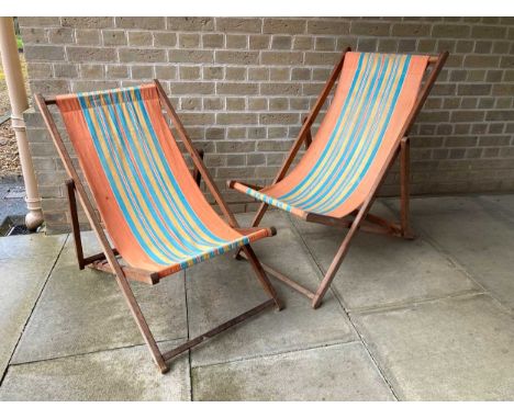 A pair of vintage deck chairs with striped fabric