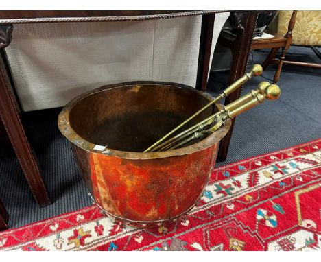 A small riveted copper copper and a set of brass fire tools