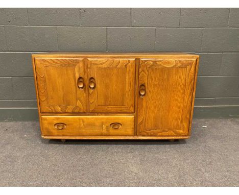 A 20th century Ercol type stained elm sideboard with three cupboard doors and single drawer, 69cm x 115cm x 44cm
