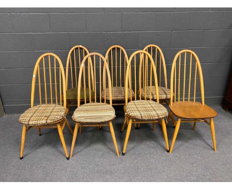 A set of seven Ercol elm seated dining chairs with arched backs, 97cm HIn overall good condition, some fading but sound with 