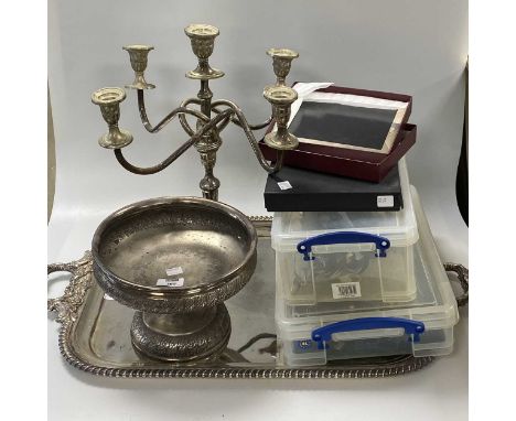 Two silver photograph frames together with an assortment of silver flatware, including some fruit eaters with filled handles,