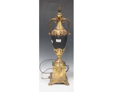 An Empire style vase lamp in black and gilt, with foliate detail and overscrolled handles. 66cm to the top of the fitting.