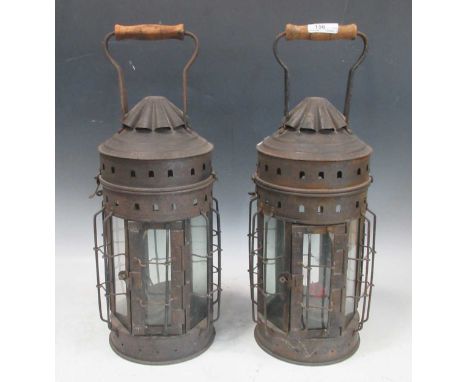 A pair of 20th century lanterns with glass panels and turned wood handles, together with a small table lamp, a brass oil lamp