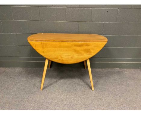 An Ercol drop-leaf dining table on square tapered legs 71cm x 65cm x 113cm (closed) or 71cm x 124cm x 113cm (open)