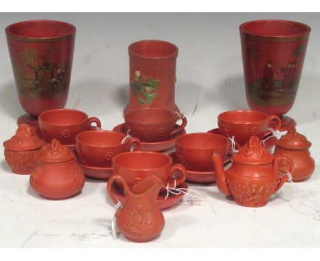 A collection of 19th century and later miniature redware items, to include tea cups, saucers, jugs tea pots, some with leaf m