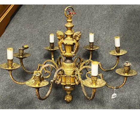 A 19th century 8 branch chandelier with cherub masks wired for electricity 56cm High 87 diameter