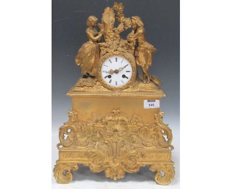 A late 19th century French gilt metal mantel clock, with courting couple pediment, on scroll feet, 44cm x 31cm x 11cm 3" diam