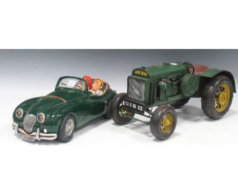 Modern resin model of a couple in a dark green sports car, Guillermo Forchino, titled 'The Dream' design, numbered no. 02157?