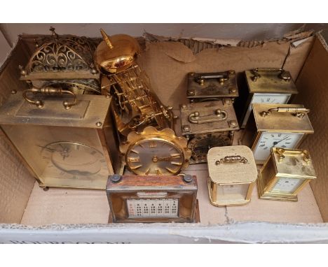 A collection of brass clocks and timepieces, to include a vintage electroplate desk calendar, 14.5cm wide. (11) 