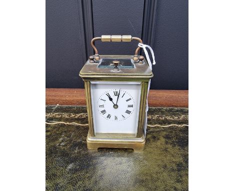 A small antique brass carriage clock,&nbsp;with push button repeat and gong strike, height including handle 12.5cm, with wind