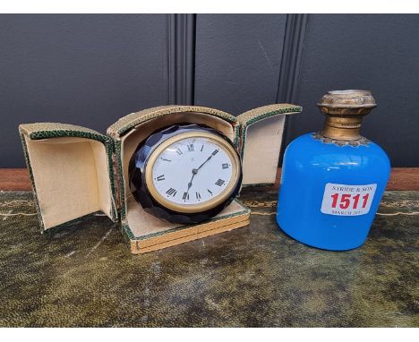 A vintage faceted glass easel back timepiece,&nbsp;9cm wide, in case; together with a 19th century blue glass scent bottle, t