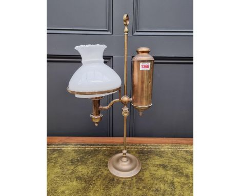 An antique brass student's oil lamp, with associated opaque glass shade, 54.5cm high.&nbsp; 