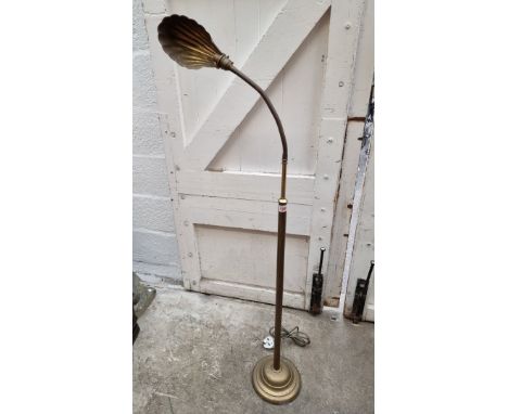 A vintage brass articulated standard lamp, with brass shell shade.&nbsp; 