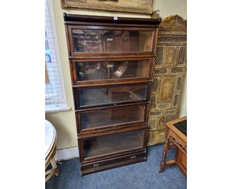 An early 20th century mahogany Globe Wernicke five tier sectional bookcase, with&nbsp;apron drawer, 86.5cm wide. 