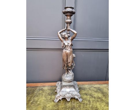 A patinated spelter figural candlestick,&nbsp;79cm high, (s.d.) 