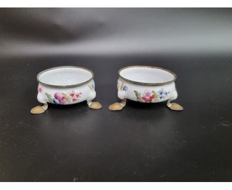 A pair of 18th century French enamel tripod salts,&nbsp;6.5cm diameter, (losses). 