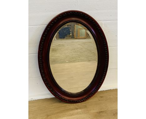 Mahogany oval mirror with bevel edge glass, 68 x 93cms. Estimate £20-40.