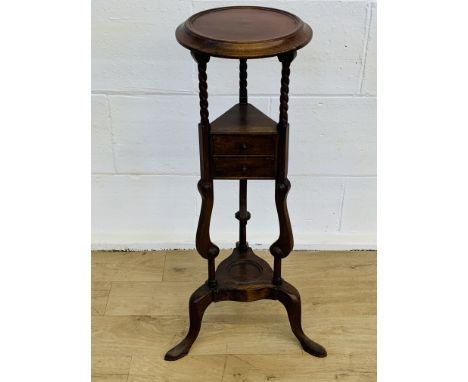 Mahogany jardiniere stand with two drawers and open display shelf on three feet, 86cms. Estimate £15-30.