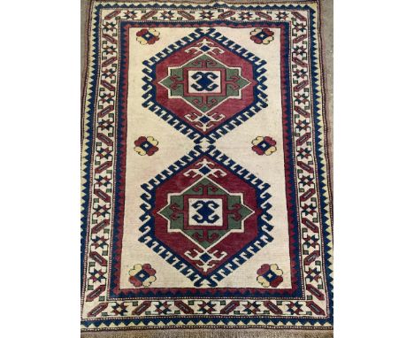 Handmade wool cream ground carpet decorated with geometric patterns, 160 x 120cms. Estimate £60-80.