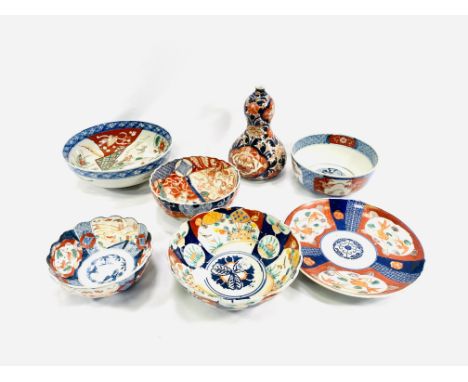 A collection of six Imari bowls together with an Imari gourd vase, 19cm. Estimate: £50-80