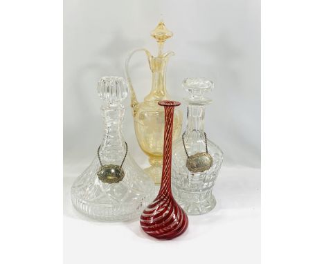 A cut glass ships decanter with silver plate Brandy label, 27cms; a cut glass decanter with silver plate label, 26cms; an amb