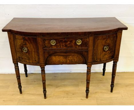 Mahogany bow fronted sideboard with two centre drawer, cellaret, cupboard to one side on turned legs, 138 x 60 x 93cms. Estim