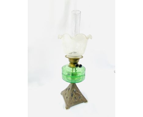 A Victorian oil lamp on cast metal base and green glass reservoir, 55cm; together with a brass oil lamp with opaque glass sha