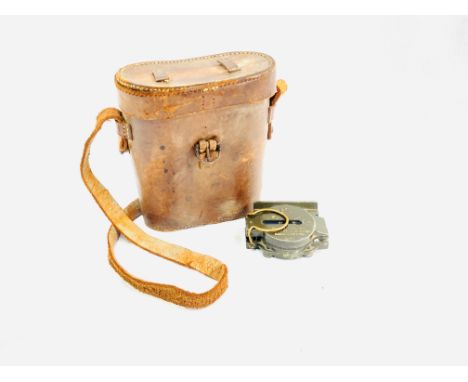 A United States military compass manufactured by Brunson Instrument of Kansas City; a pair of leather covered binoculars writ