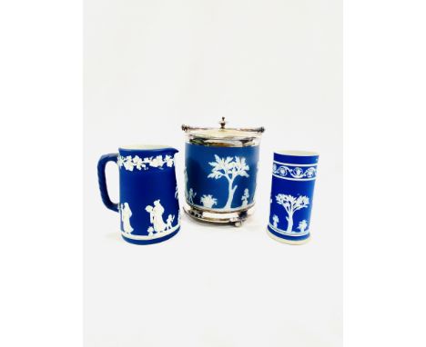 A Wedgewood blue and white jasperware biscuit barrel with silver plate mounts, 17cm; a Wedgwood jasperware jug, 13cm; a Wedgw