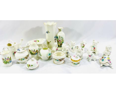 Twenty one items of Aynsley china, including a vase, 21cm; watering can, wheelbarrow and animals. Estimate: £20-40