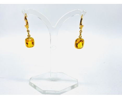 A pair of hallmarked 9ct gold earrings set with yellow stones. Estimate: £35-50