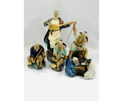 Four ceramic figures of Oriental gentlemen, largest 23cms; together with A Nao figure of a kneeling girl and dove, 23cms; a N