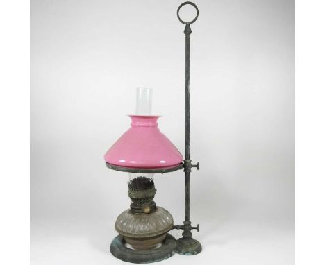 A student's oil lamp, with a pink glass shade, 63cm high
