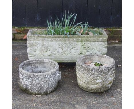 A cast stone garden trough, 72cm diameter, together with two planters (3)