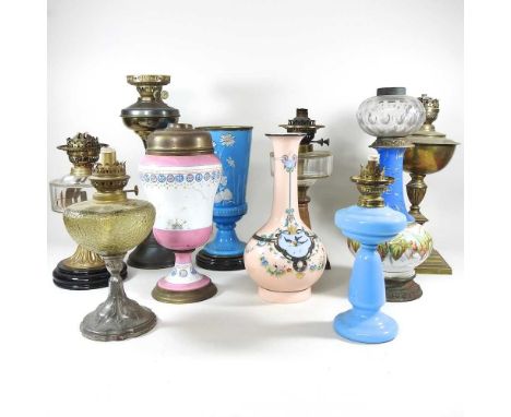 A collection of ten various brass and porcelain oil lamp bases (10) Highest is 48cm H.