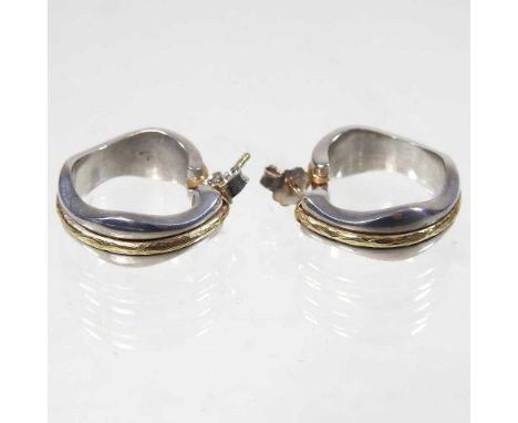 A pair of Georg Jensen silver and 18 carat gold earrings, of hoop shape, designed by Regitze Overgaard, stamped 312, 15g gros