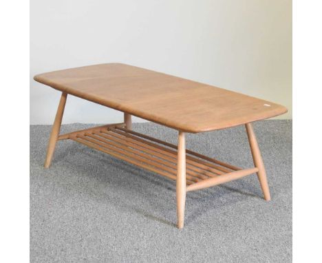 A 1970's Ercol light elm coffee table, on a splayed base106w x 47d x 37h cmOverall condition is complete and usable. Collecte