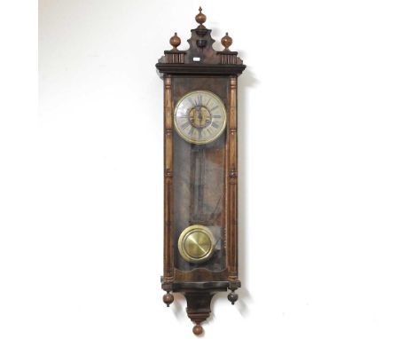 A late 19th century Vienna style walnut cased wall clock, with a glazed case, 124cm high