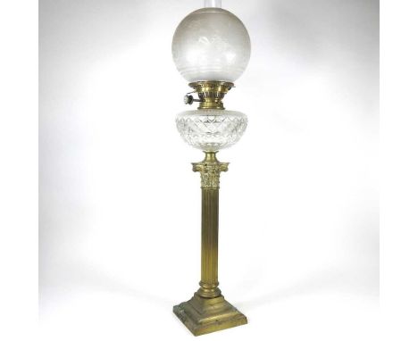 An early 20th century brass oil lamp, in the form of a column, with a heron etched glass shade, 86cm highMetal is tarnished, 