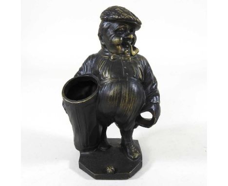 A bronzed figure of a golf caddy, 18cm high