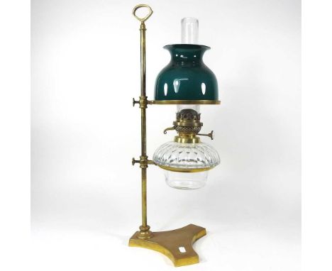 A 19th century adjustable brass student's oil lamp, with a green glass shade, 56cm high