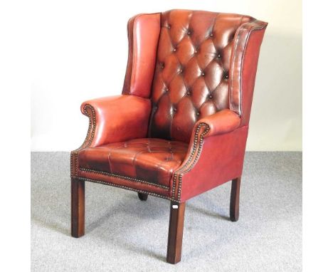 A red leather armchair, with a button back, on square legs72w x 96hcm