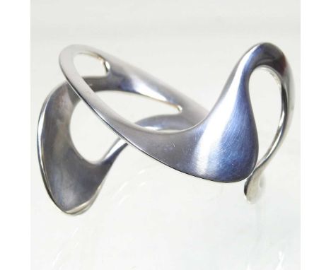 A Georg Jensen silver bangle, of organic form, stamped marks, 90g, 10cm wideOverall condition looks to be complete and undama