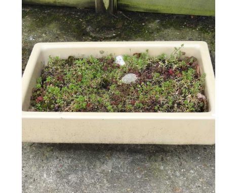 A glazed stoneware garden trough, planted, 75cm wide
