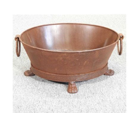 A modern iron oval trough, on paw feet, 58cm wide