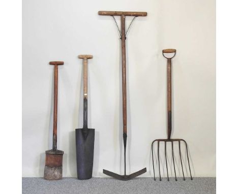 A collection of vintage wooden gardening tools, to include to spades and a fork (4)